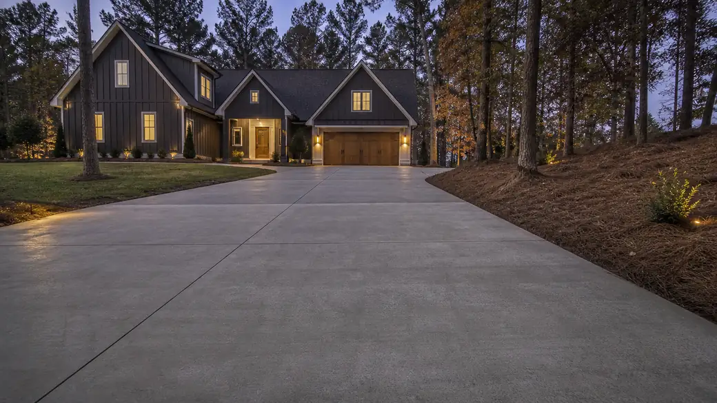 concrete construction services completed by a local contractor at a charcoal farmhouse-modern home in Lawrenceville, GA, at blue hour.